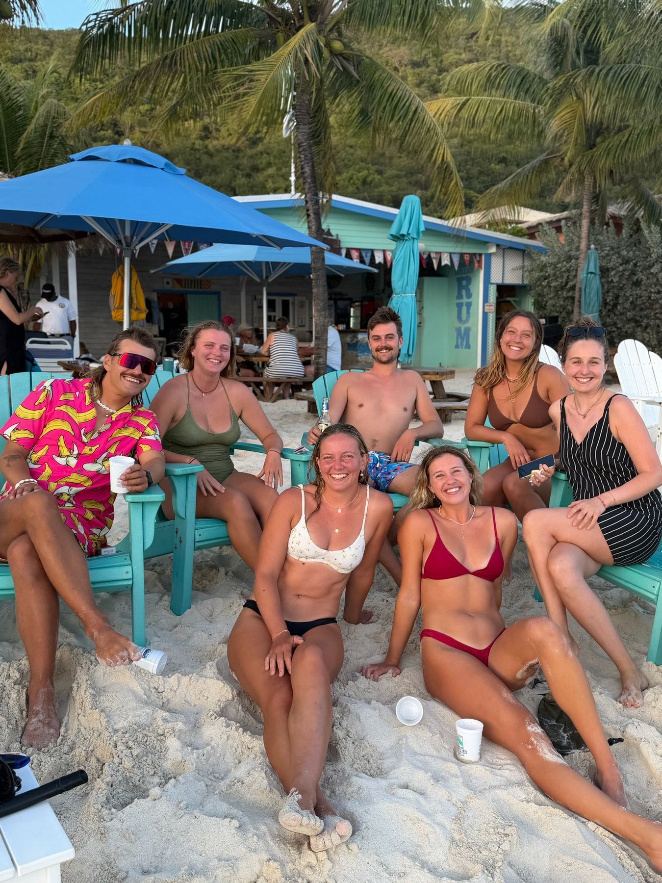 Crew relaxing in beach chairs at a beach bar