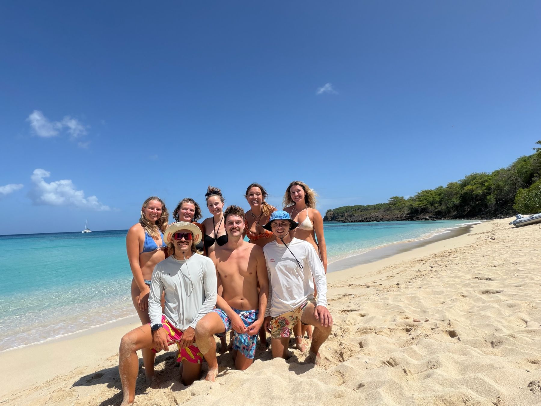 Crew group photo on a white sand beach