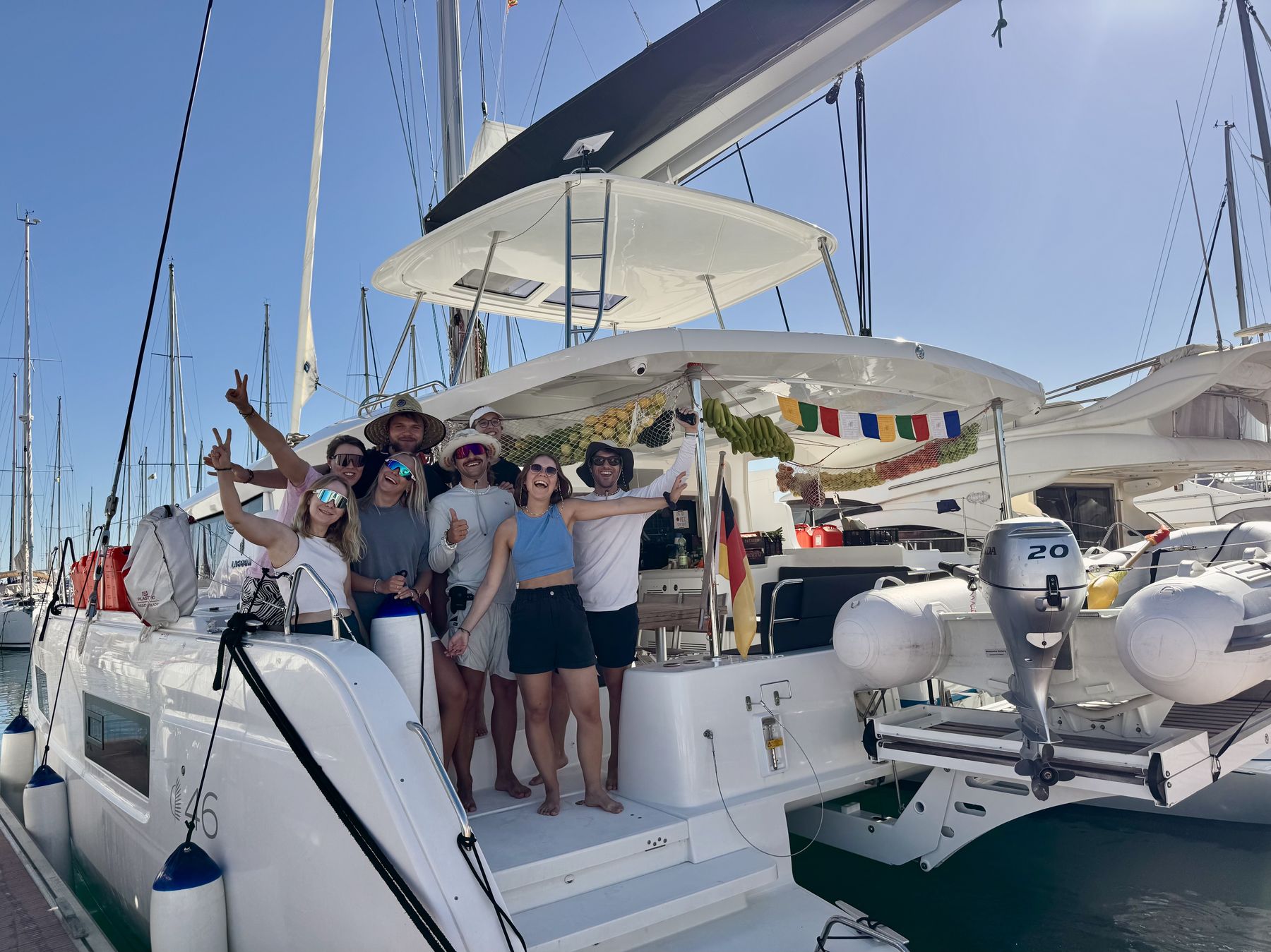 Crew group photo on deck in a marina